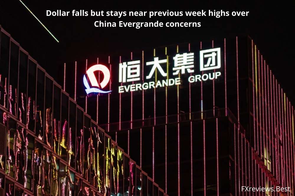 Dollar falls but stays near previous week highs over China Evergrande concerns