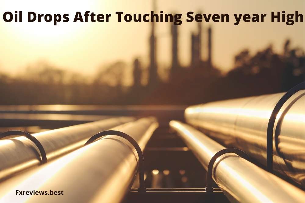 Oil drops after touching seven year high